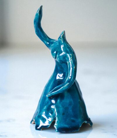 Handmade blue glazed ceramic ballerina sculpture with raised arms and flowing dress, presented in wooden gift box – Dance Is Ceramica