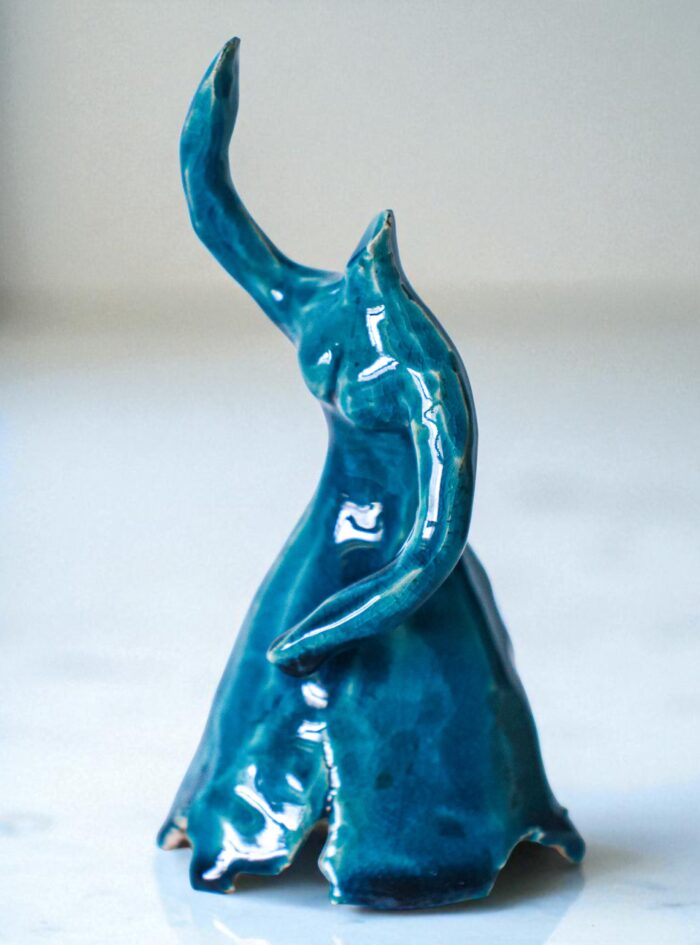 Handmade blue glazed ceramic ballerina sculpture with raised arms and flowing dress, presented in wooden gift box – Dance Is Ceramica