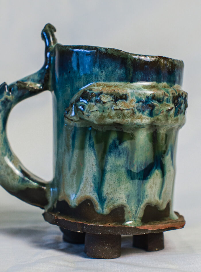 beer mug (14 of 28) Green medieval ceramic tankard with a textured band, curved handle and small dark clay feet