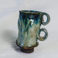 Handmade 300 ml ceramic beer mug with green-blue glaze and two sculptural loop handles